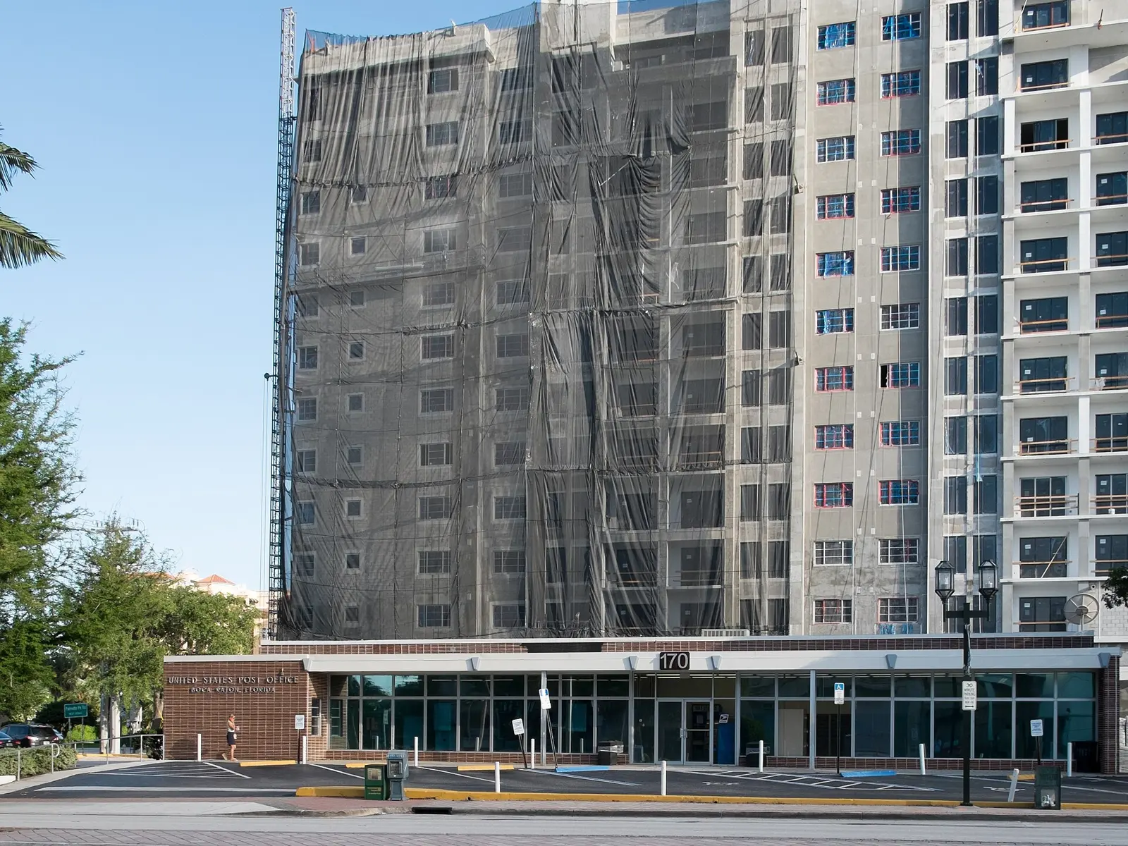 A post office at the foot of an apartment tower under construction in Boca Raton.