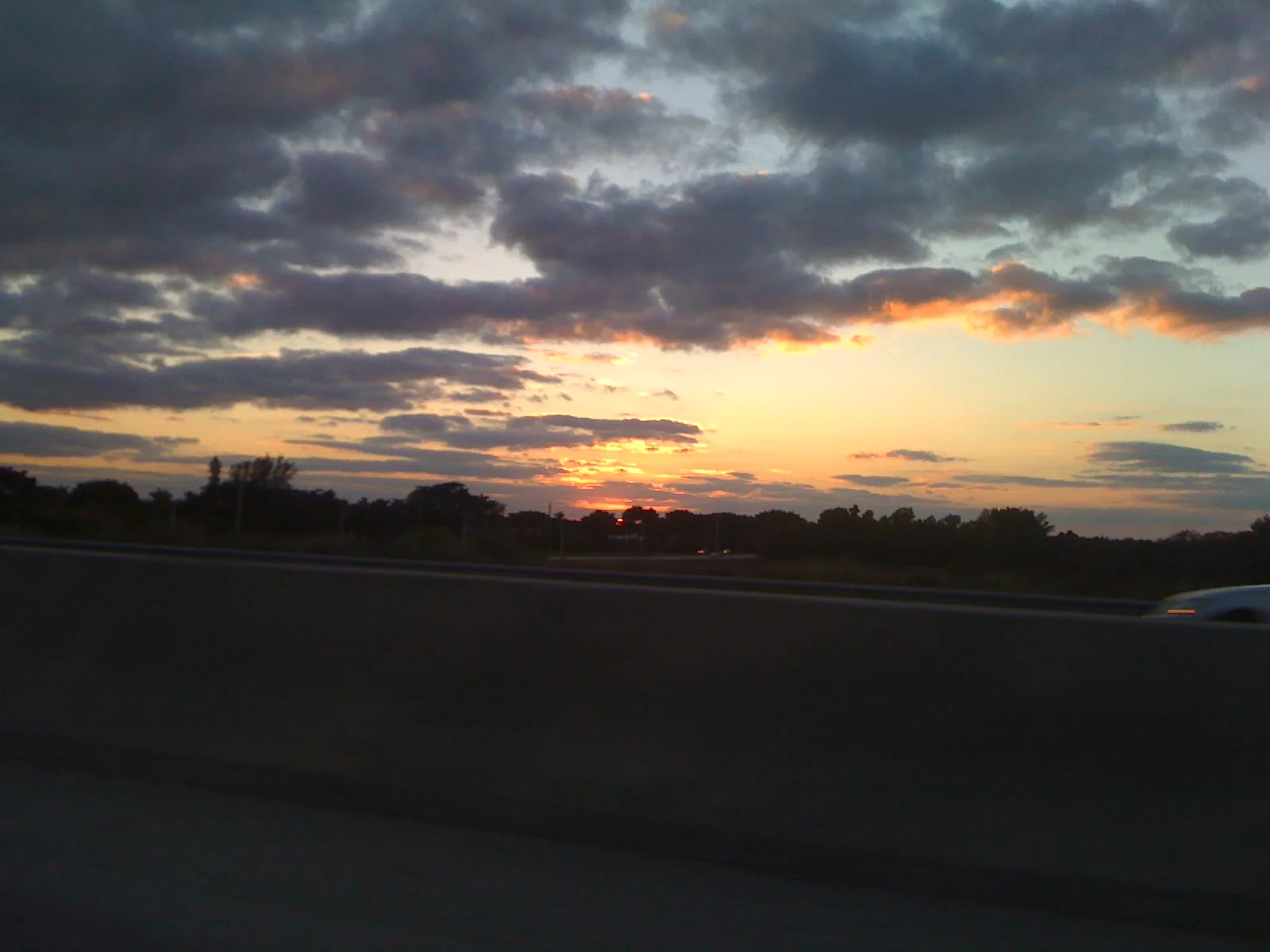 Sunset over Florida's Turnpike at Clint Moore Road, at the northwest corner of Woodfield Country Club in Boca Raton