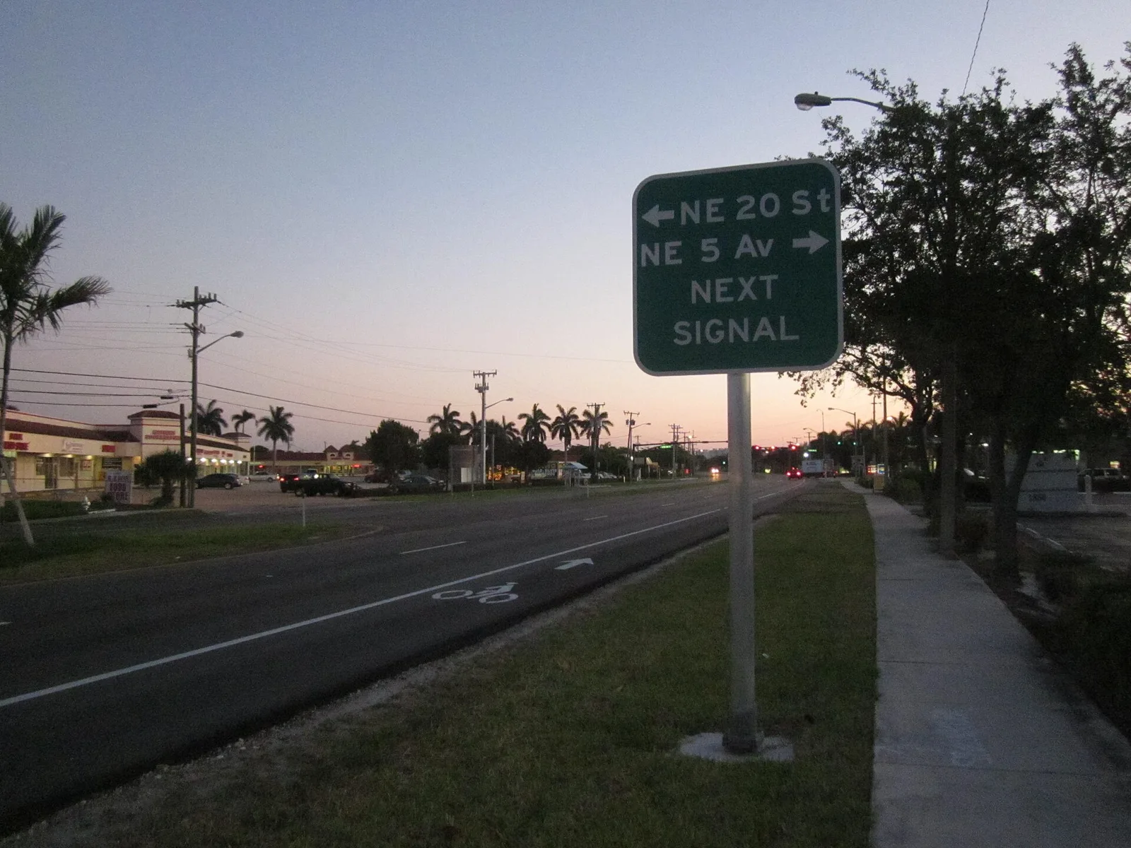 Federal Highway (U.S. 1) in Boca Raton at dusk, with a sign for Northeast 20th Street.